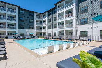Resort-style pool with tanning ledge and sundeck